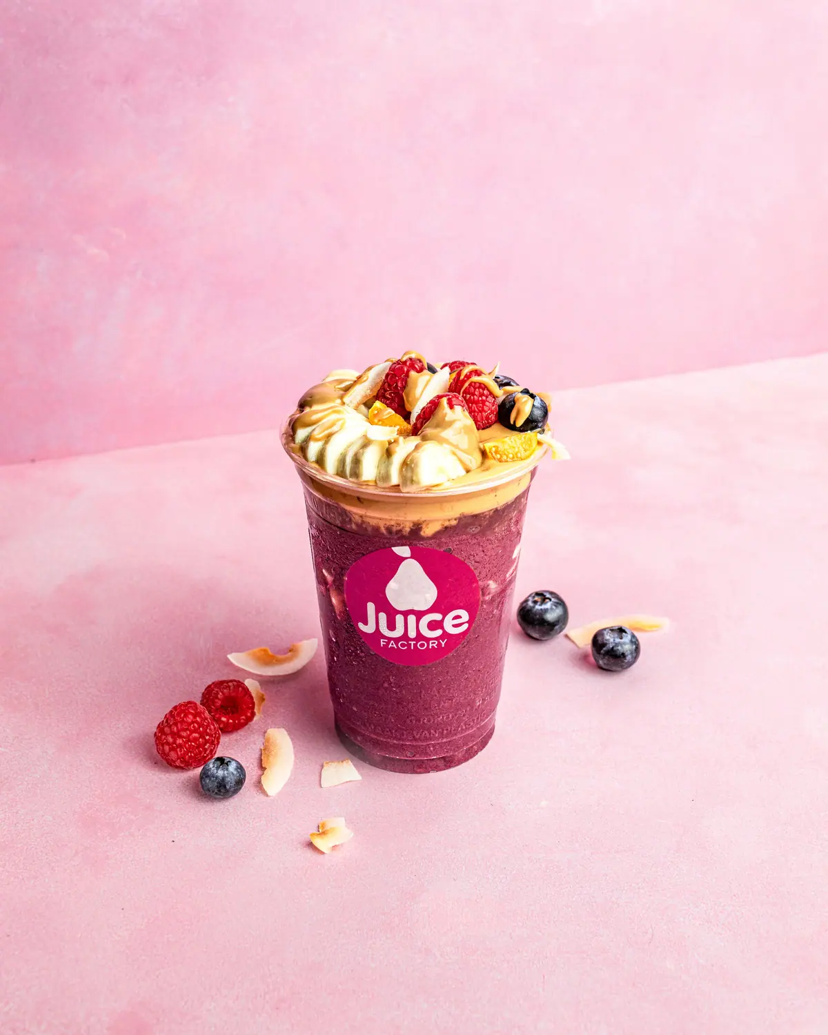 Açaí cup topped with banana, raspberries, blueberries and peanut butter