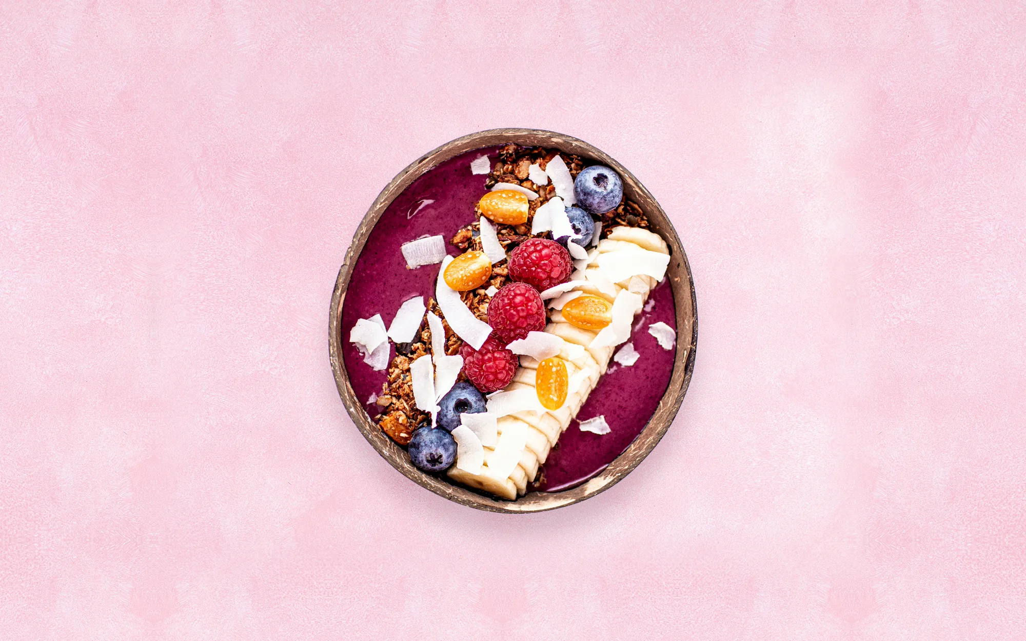 Açaí Bowl Classic von oben: violettes Açaí mit Banane, Himbeeren, Heidelbeeren, Kokoschips und Granola