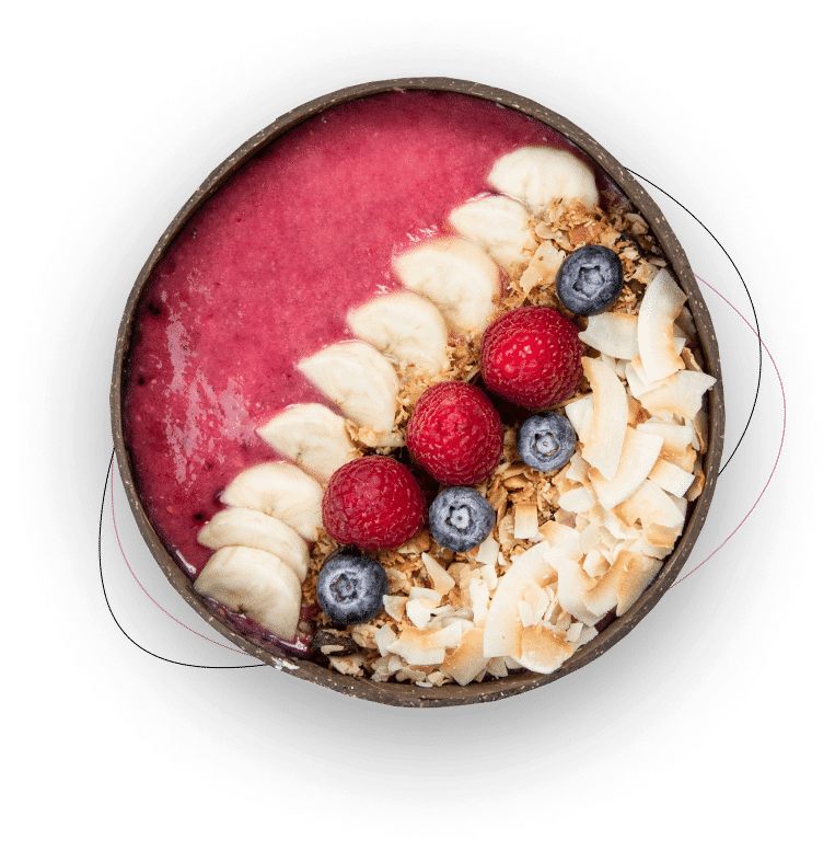 A smoothie bowl topped with sliced bananas, blueberries, raspberries, granola, and coconut flakes, arranged in rows on a pink smoothie base in a round bowl.