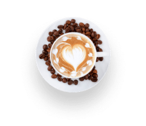 Eine Tasse Cappuccino mit herzförmiger Latte Art, umgeben von Kaffeebohnen auf einer weißen Untertasse, von oben vor einem weißen Hintergrund betrachtet.