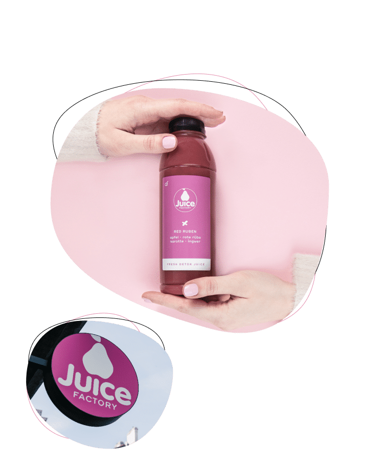 A person holds a bottle of red juice labeled Juice Factory on a pink background. Below, a round outdoor sign with the same logo and text is visible.