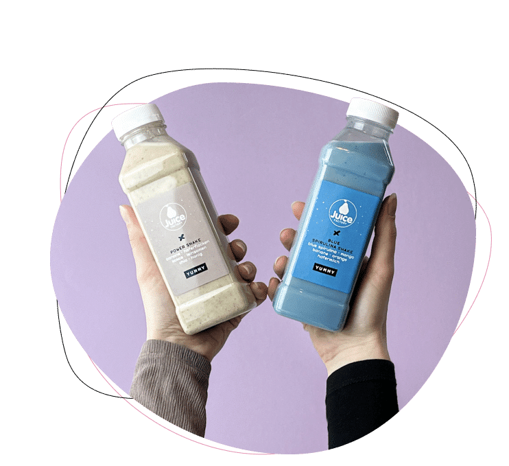 Zwei Hände halten Plastikflaschen mit Juice XC-Getränken, eine beige und eine blaue, vor einem pastellvioletten Hintergrund. Jede Flasche hat einen weißen Deckel und ein Etikett. Eine dekorative Linie umrahmt die Szene.